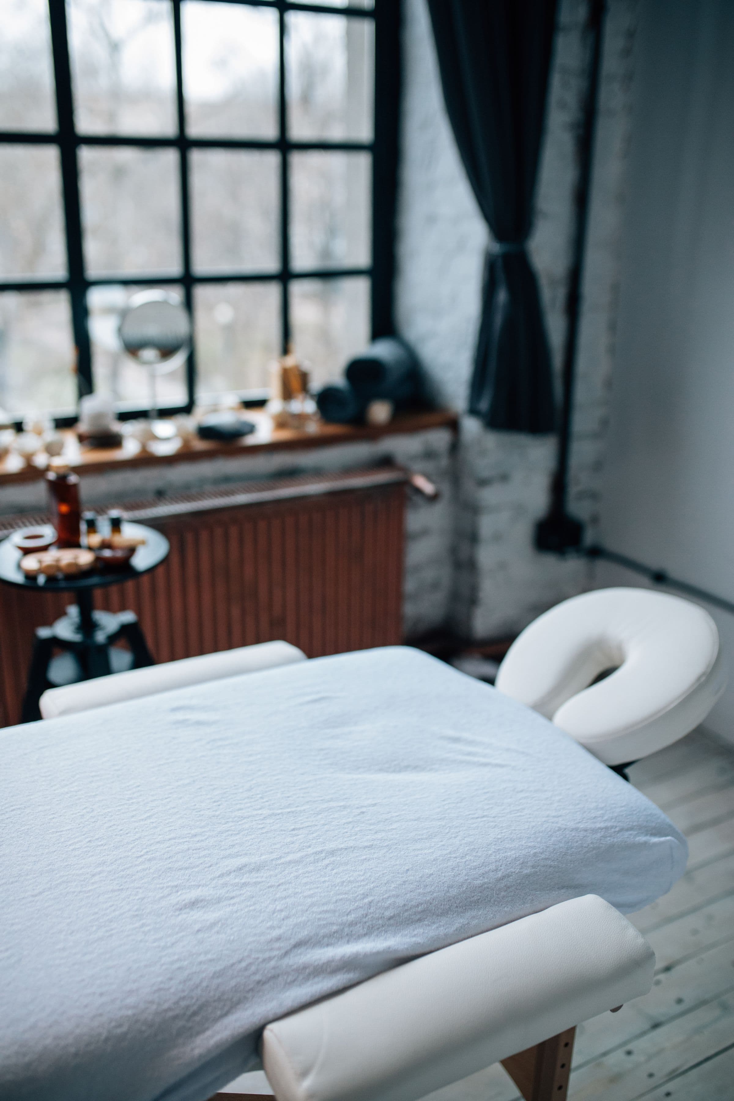 Massage table set up in a calm, naturally lit room